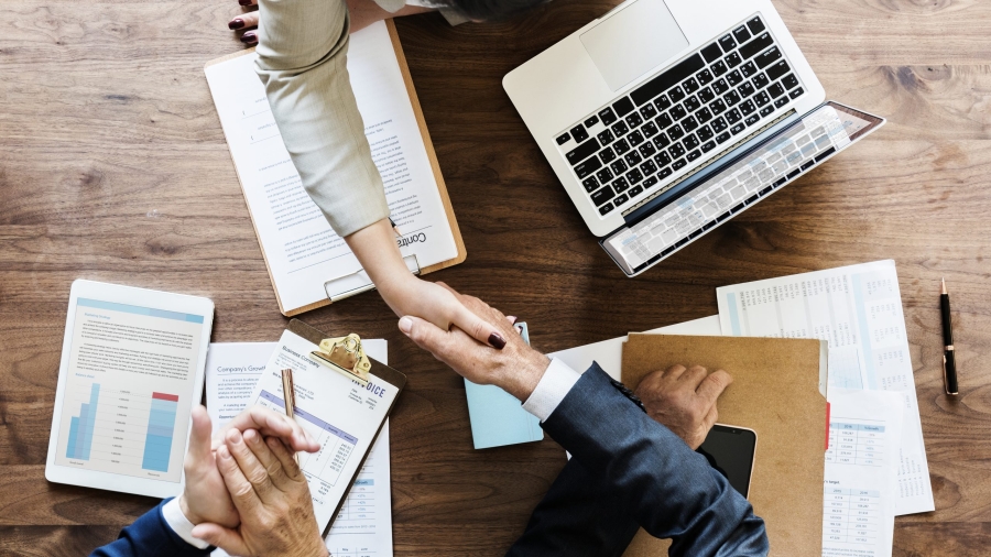 Business people shaking hands together